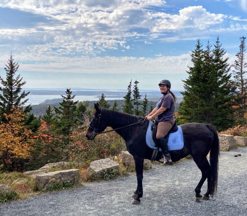 Horse book author Laura Holt-Haslam riding Soprano on Day Mountain in 2021.